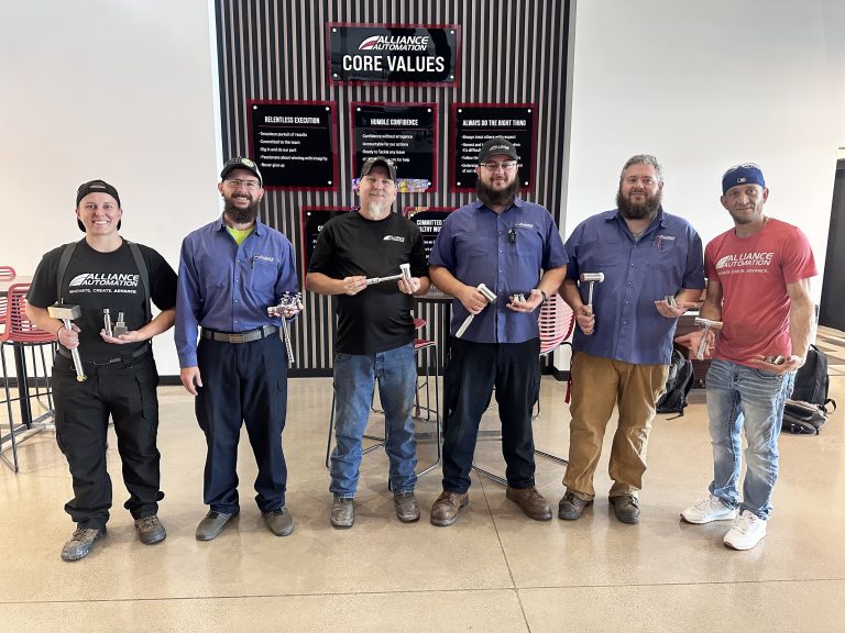 Apprentices proudly presenting their completed automation projects together at Alliance Automation.