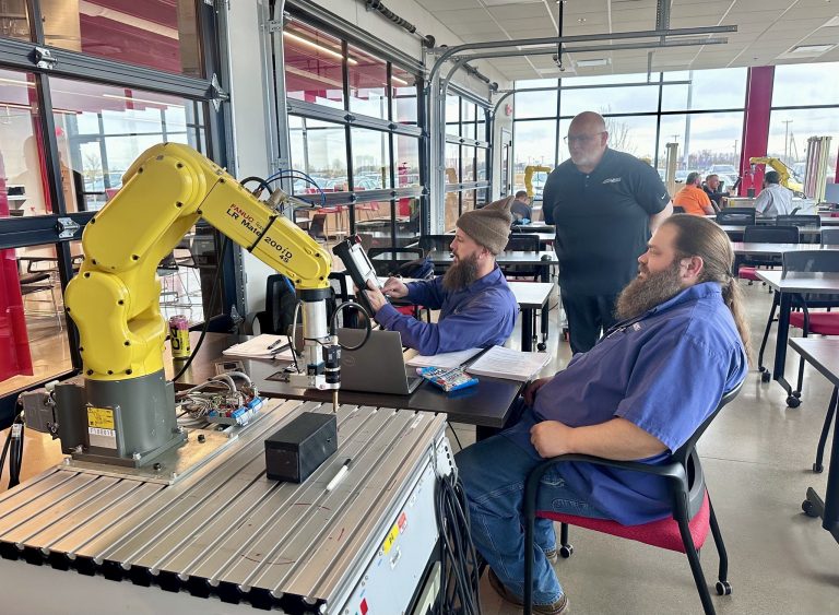 Group of apprentices collaborating in a PLC class at Alliance Automation.
